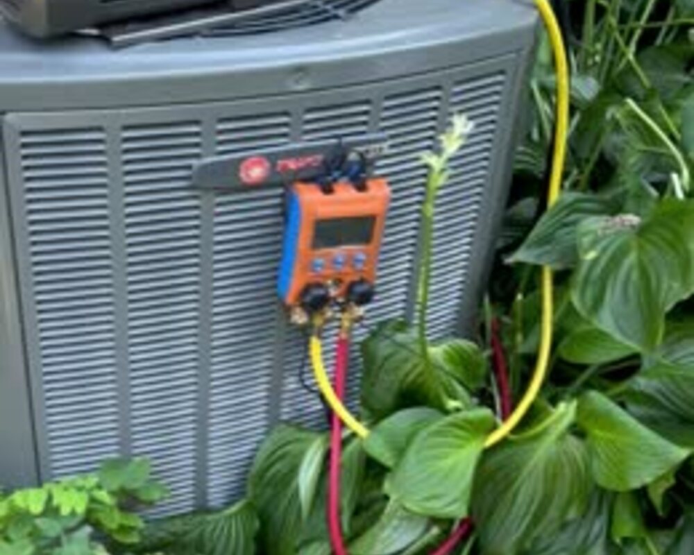 HVAC diagnostic gauges connected to an outdoor unit