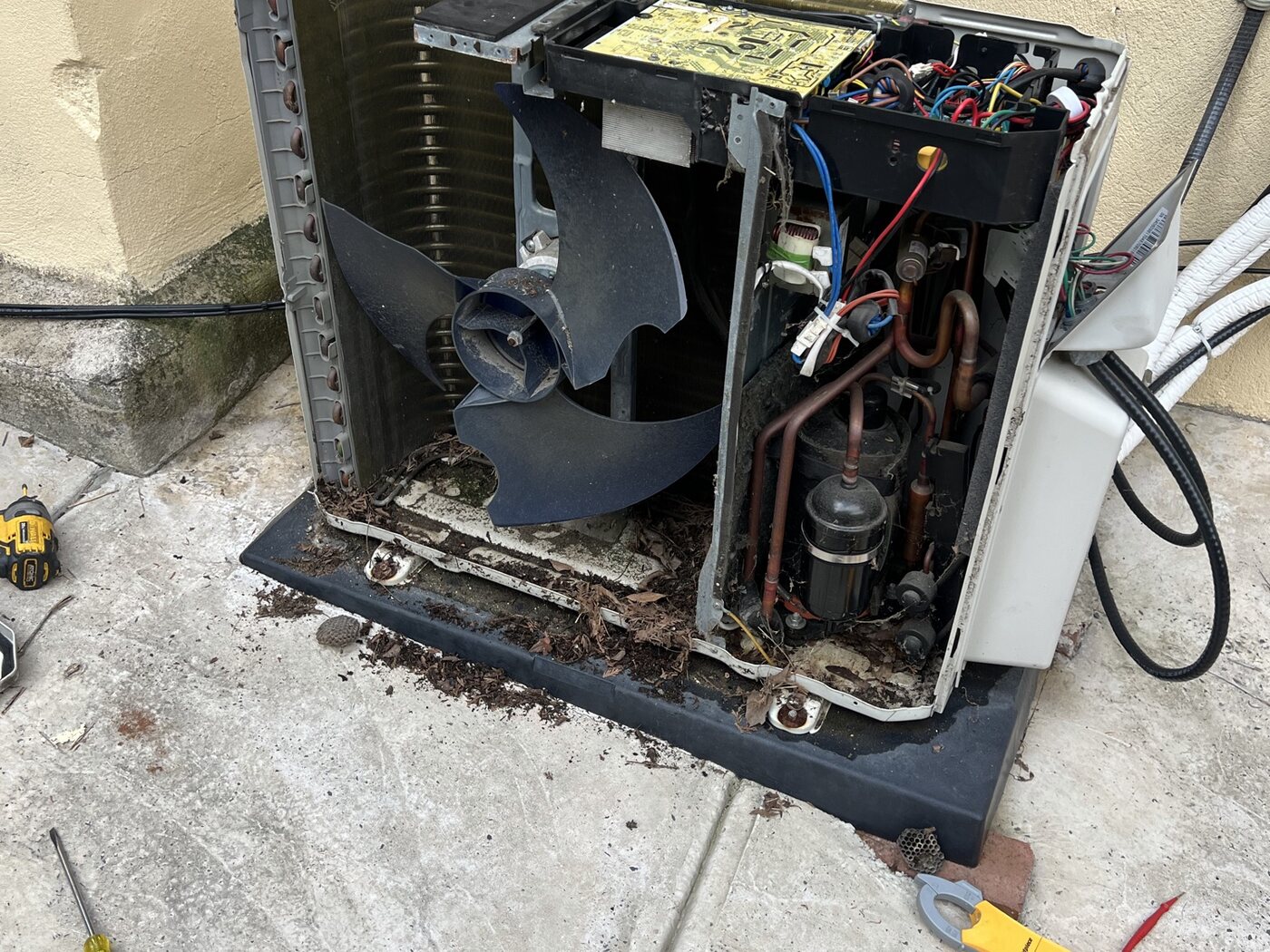 Open outdoor HVAC unit being serviced by Rojas Pro HVAC